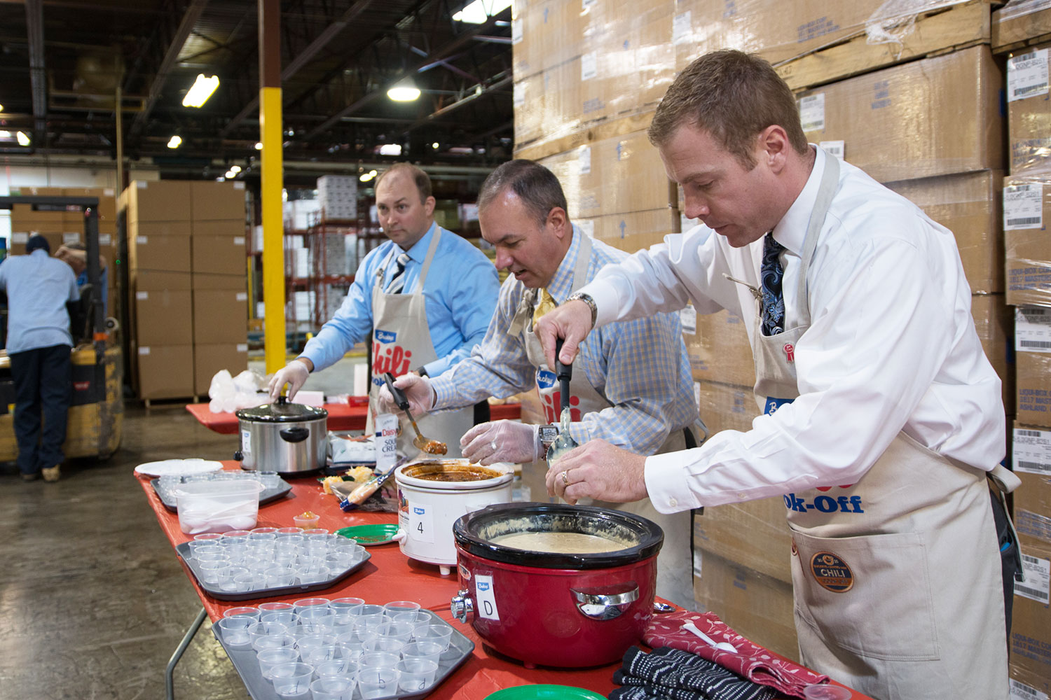 Buckeye employees scooping out chili from crockpots.