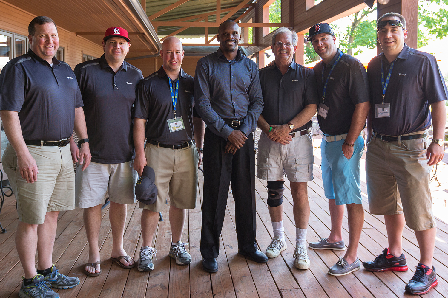 Group of Men at the National Sales Meeting standing with Issac Bruce.