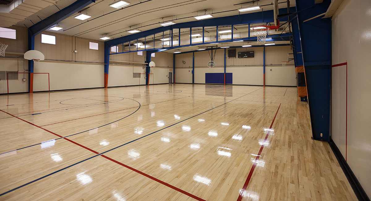 A shiny wood floor in an empty school gym