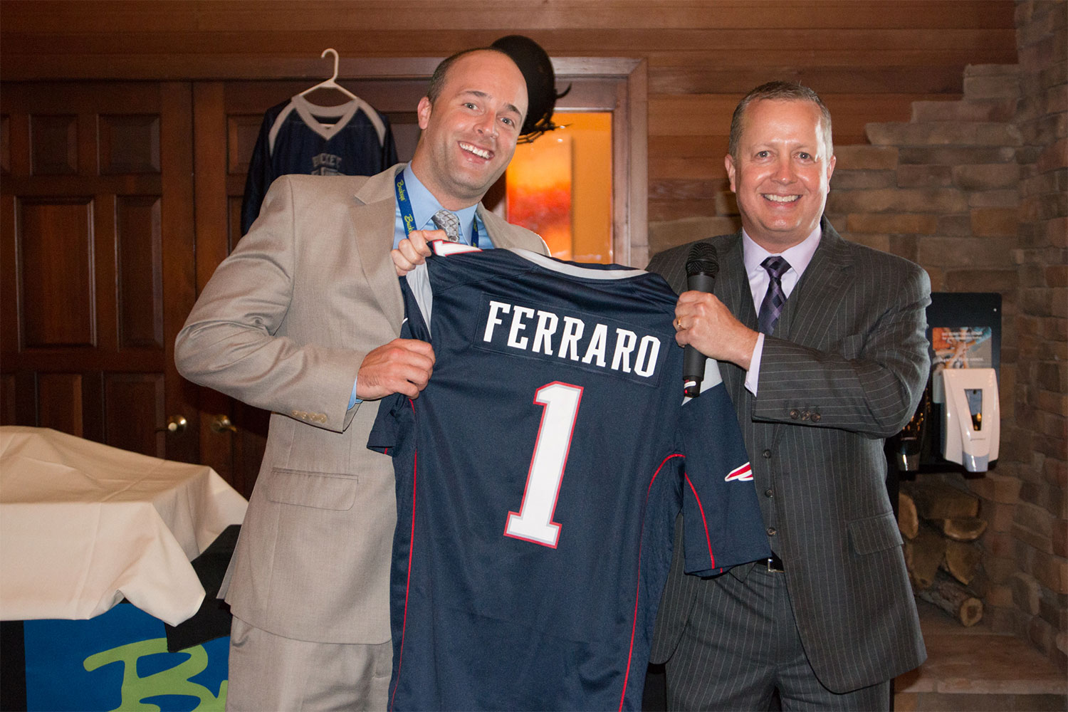 Man being presented with a jersey