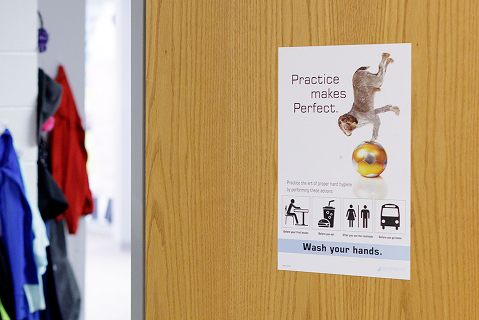 Practice makes perfect poster on Door in school