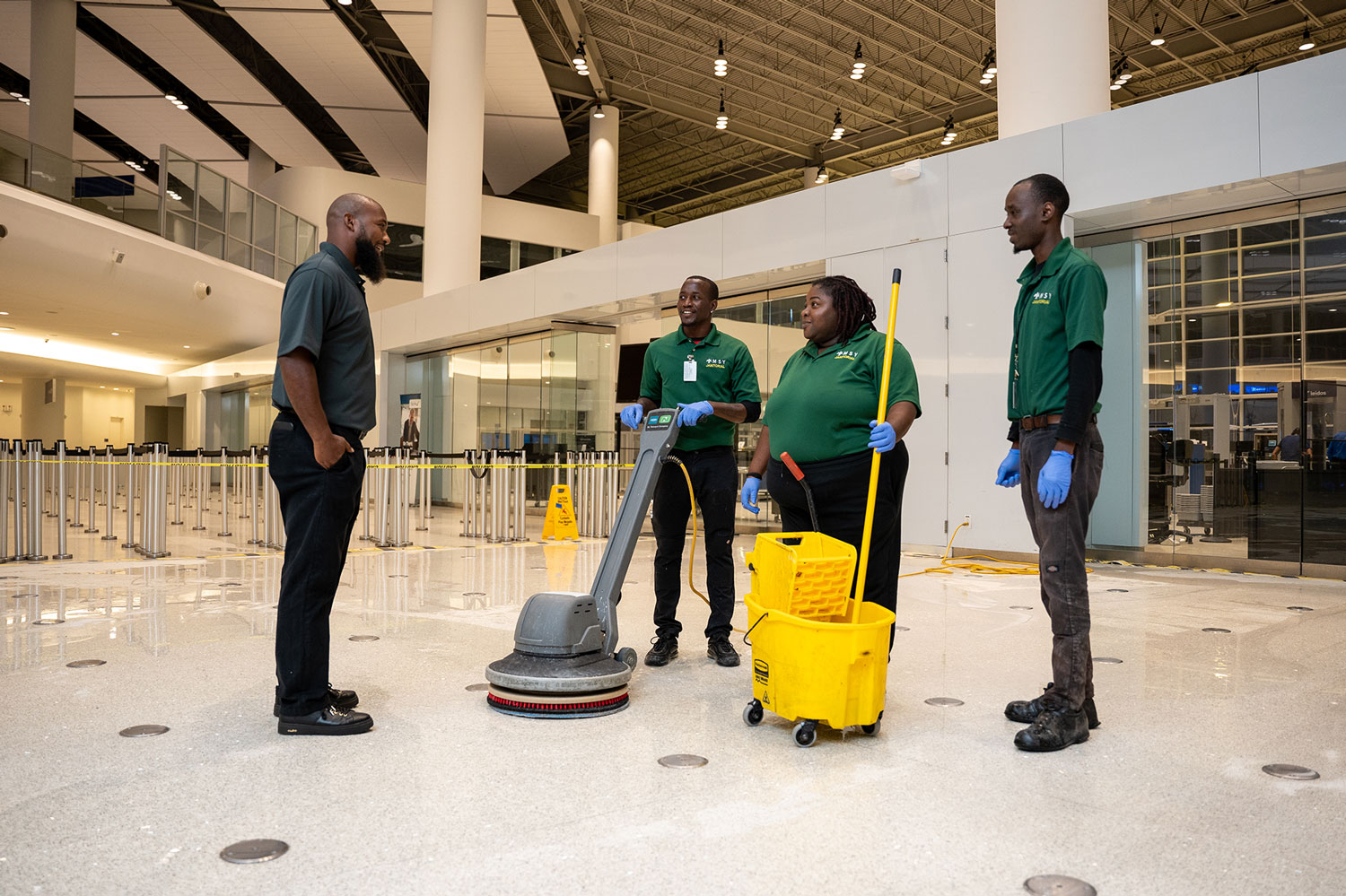 Group of custodians talking to each other in the New Orelans airport