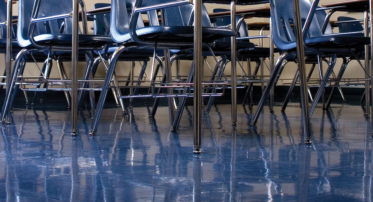 School desk chairs on a shiny blue floor
