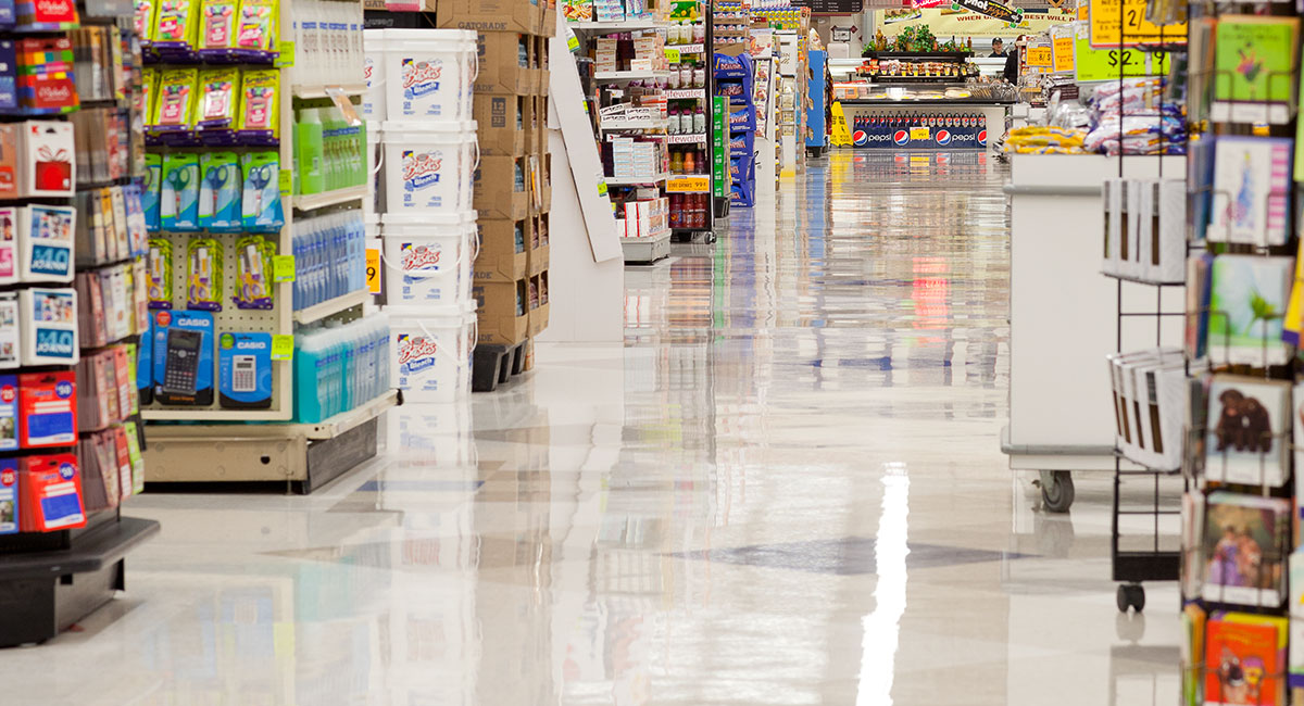 A shiny floor in a grocery store aisle