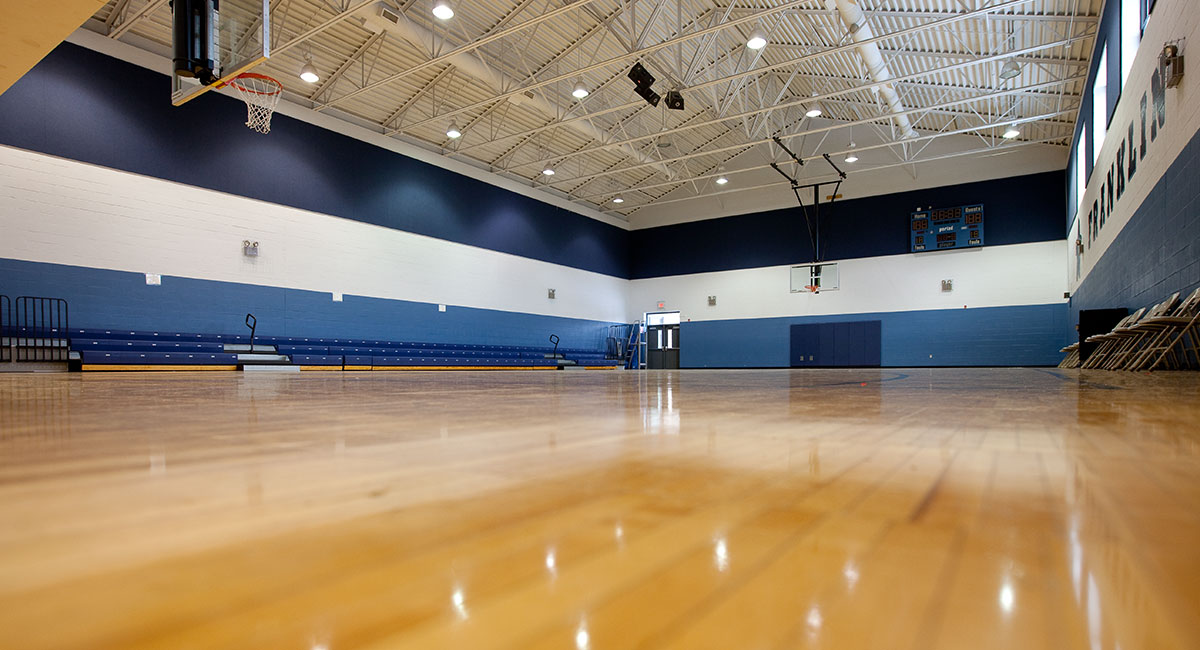 Low to the ground perspective on wood floor in a school gym