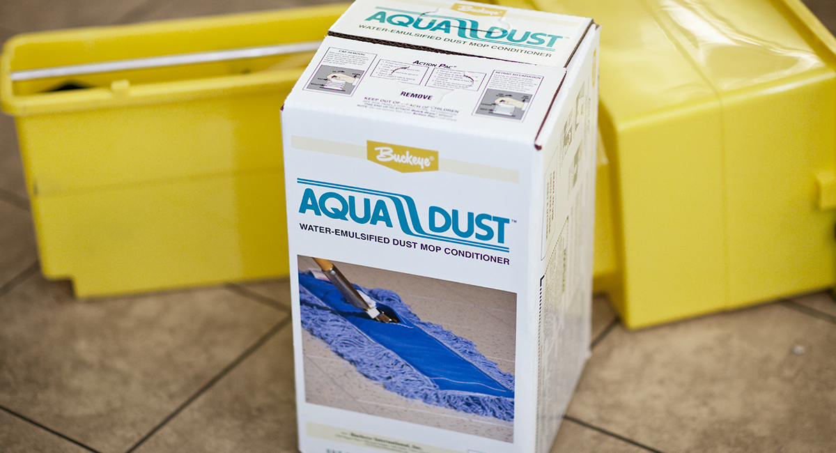 Aqua Dust Action Pac sitting on a hard floor next to a mop bucket